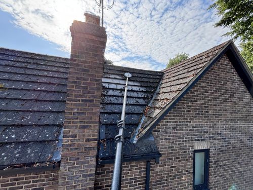 before Roof moss removal in Rushden